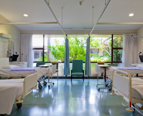 Front view of a hospital room with multiple beds