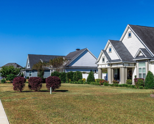 new construction neighborhood of hardy board cottage coastal style homes with landscaped yards