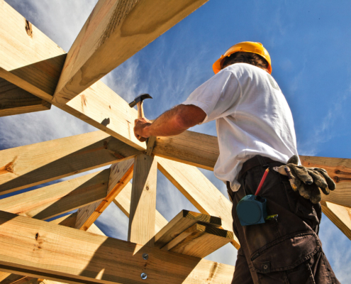 roofer ,carpenter working on roof structure at construction site